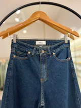 Pantalón de jean azul oscuro, de tiro alto y corte wide leg.