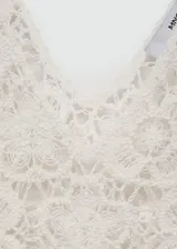 Top de crochet color blanco con escote en V y sin mangas.