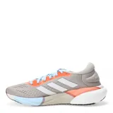 Championes Adidas Supernova 2 X color gris con detalles en naranja y celeste, con las tres tiras blancas características de la marca.