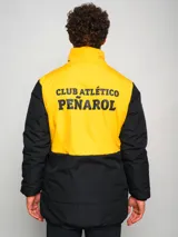 Parka de hombre bicolor negra y amarilla con escudo del club deportivo Peñarol en el pecho.