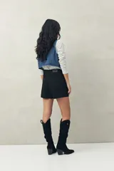 Short negro de tiro medio, con calce al cuerpo y dobladillos en los bordes.