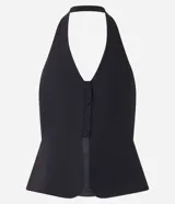 Chaleco negro con frente única, corte peplum, estructura sastre y cierre frontal con botones.