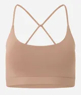 Top deportivo negro confeccionado en microfibra sin estampa, con espalda abierta y breteles finos cruzados.