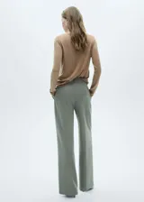 Sweater de punto fino color beige, con cuello redondo y mangas largas.