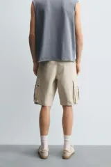 Bermuda cargo de algodón color marrón oscuro, tiro medio, corte regular, con bolsillos laterales de parche con solapa y bolsillos traseros de vivo.