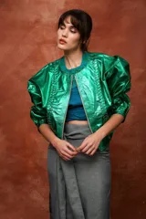 Campera marrón de cuero con cierre frontal, corte oversize, mangas abullonadas y puños ajustados.