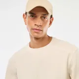 Sweater color crudo de punto fantasía con cuello redondo y mangas largas. Corte regular.