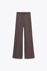 Pantalón palazzo color marrón con hilo metalizado, tiro medio y cintura elástica ajustable con cordones.