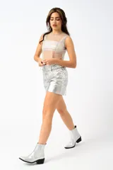 Short dorado de cuero sintético con cadena plateada en la cintura.