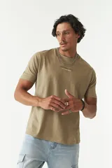 Remera color arena con estampado pequeño en el pecho.