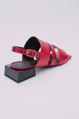 Sandalias bajas color crema con tres tiras en la capellada, una de ellas con textura tipo piel de cocodrilo. Pulsera con hebilla para ajustar al tobillo y taco cuadrado color negro.