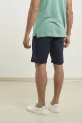 Bermuda de gabardina color azul oscuro, corte recto, con bolsillos laterales y traseros.