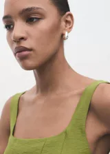 Vestido midi color verde lima, sin mangas, con escote cuadrado y tirantes anchos. Presenta un diseño evasé con costuras decorativas verticales y cierre de cremallera en la espalda.