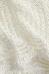Short de playa tejido al crochet color blanco, con cintura elástica y cordón de ajuste.