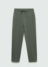Pantalón negro de piqué con cintura elástica, tiro alto, diseño jogger, bolsillos laterales y costuras decorativas.