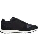 Zapatillas de running Tommy Hilfiger color negro, con detalles de cuero y gamuza. Presentan una suela dentada blanca y una franja tricolor en el lateral.