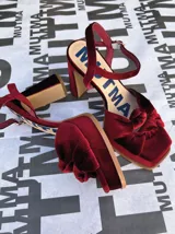 Sandalias de terciopelo color borgoña con correa trasera ajustable, doble moño en la punta y taco de 10,5 cm de altura.