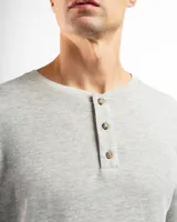 Remera de manga larga confeccionada en tela mini piqué de algodón, con cuello tipo Henley con tres botones y puños acanalados.