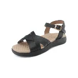 Sandalias bajas negras con tiras cruzadas en el empeine, pulsera al tobillo con hebilla dorada y plantilla color nude.