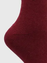 Calcetines grises de largo medio, tejido grueso y puño suave.