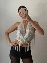 Top halter blanco con lentejuelas plateadas y flecos.