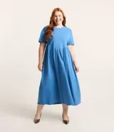 Vestido midi celeste de media malla, con cuello redondo, manga corta abullonada y corte en V en la cintura.