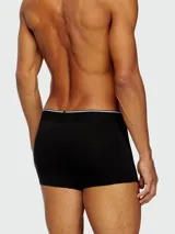 Pack de tres bóxers Diesel, uno gris liso con pretina gris claro con logo, y dos con estampados.