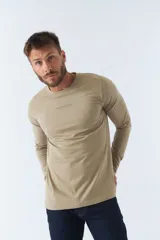 Remera blanca de manga larga con cuello redondo y logo estampado en el pecho.