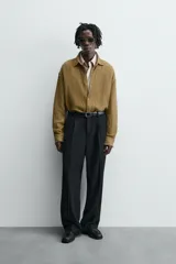 Sobrecamisa color caqui de algodón y lino con efecto arrugado, corte relaxed fit, cuello solapa, manga larga con puños abotonados y cierre frontal con botones.