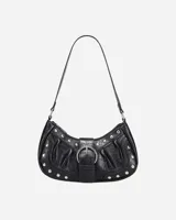Bolso de hombro negro con textura de cuero y tachuelas plateadas. Presenta un asa corta y una hebilla plateada en la parte delantera.