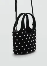 Bolso negro con lunares plateados, forro interior, doble asa corta y asa larga extraíble.