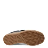 Championes urbanos negros de caña baja con capellada acolchada con patrón de ondas y suela de goma color caramelo.