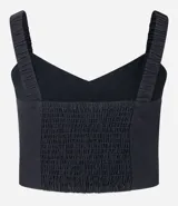 Blusa cropped negra de lino y algodón, con escote corazón, breteles anchos y detalle de bordado ondulado en el ruedo.