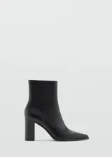 Botín negro de cuero con puntas agudas y tacón alto.