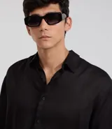 Camisa masculina de lino puro, color negro, con corte relajado, cuello inglés y manga larga con puños abotonados.