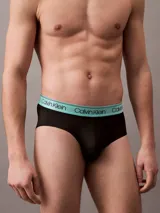 Pack de tres slips negros Calvin Klein con cintura elástica en colores lila, amarillo y celeste, con el logo de la marca.