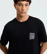 Remera negra de algodón con estampado psicodélico y lettering "The Wild Doesn't Wait" en el frente y la espalda. Diseño de corte comfort, cuello redondo y manga corta.