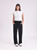 Pantalón negro de tela suave, corte recto y cintura alta con cordón ajustable.