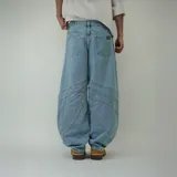 Pantalón de jean celeste, corte ultra baggy con diseño de paneles y costuras a la vista.