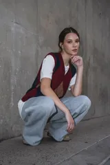 Chaleco tejido con patrón de rombos en bordeaux, azul y marrón. Con cuello en V y sin mangas.