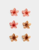 Set de seis broches pequeños con forma de flor hawaiana en colores rosa y marrón.