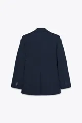 Blazer azul marino de cuello solapa y manga larga. Tiene bolsillos con solapa en delantero y cierre frontal con doble botonadura.