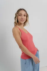Musculosa amarilla de hilo con brillo sutil, de calce ajustado y breteles finos.