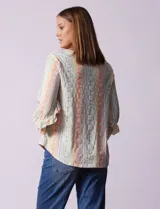 Blusa estampada con rayas verticales en tonos pastel y flores blancas. Tiene escote en V y mangas 3/4 con volados.