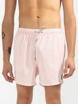 Short de baño para hombre con estampa de rayas finas color salmón y blanco. Confeccionado en tejido liviano, elástico y de secado rápido. Cuenta con cintura elástica con cordón regulable, bolsillos laterales y trasero con cierre, y suspensor de malla fina hipoalergénico.
