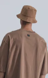 Remera color cañamo, corte crop y calce oversize, de hombros caídos y silueta relajada.