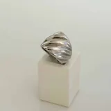 Anillo plateado de acero quirúrgico hipoalergénico con diseño de espiral.