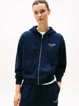 Buzo azul marino con capucha y cremallera frontal, con logo Tommy Hilfiger bordado en el pecho y en el puño.