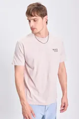 Remera de manga corta color beige con estampa en la espalda con la frase "Beach Club" y un diseño de un surfista en la playa.