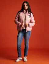 Campera puffer reversible Michael Kors color rosa con estampado de logos MK en un lado y liso en el otro. Tiene cierre central metálico, bolsillos delanteros y avíos metálicos con logo. Incluye bolsa autoportante.
